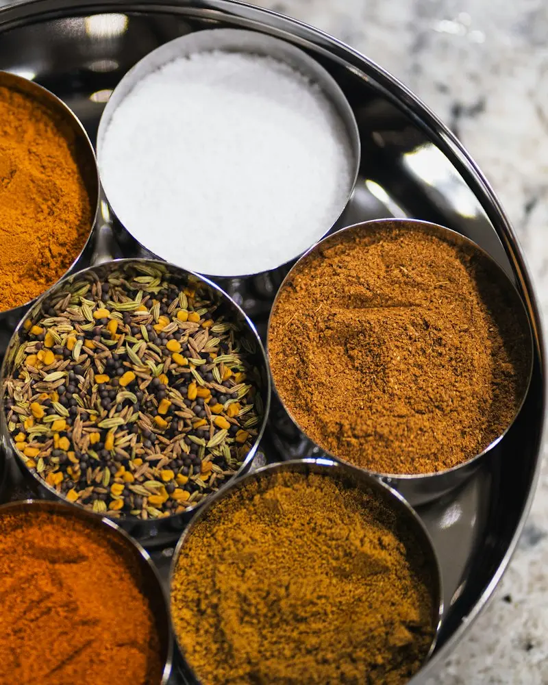 Freshly ground spices in steel bowls